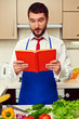 man looking in cookbook
