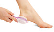 Woman having her foot scrubbed, isolated on white