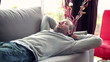 Young man taking nap on sofa at home