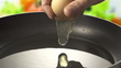 Raw egg falls on the pan