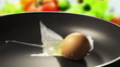 Raw egg falls on the pan