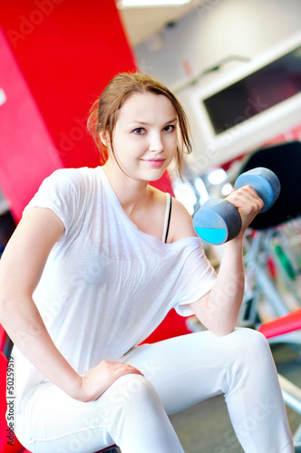 Photo: Woman doing splits with weights Woman doing splits with weights