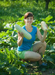 girl is picking vegetable marrow