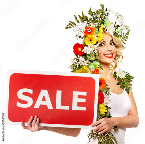 Photo: Woman holding sale banner and flower. Woman holding sale banner and flower.