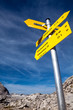 Yellow sign-board against mountain scenery