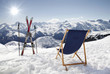Cross ski and Empty sun-lounger at mountains in winter