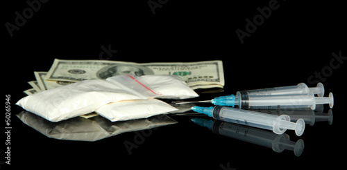 Photo: Drugs, money and syringes, isolated on black Drugs, money and syringes, isolated on black