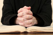 Priest reading from the holy bible, close up
