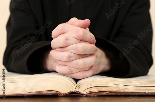 Photo: Priest reading from the holy bible, close up Priest reading from the holy bible, close up