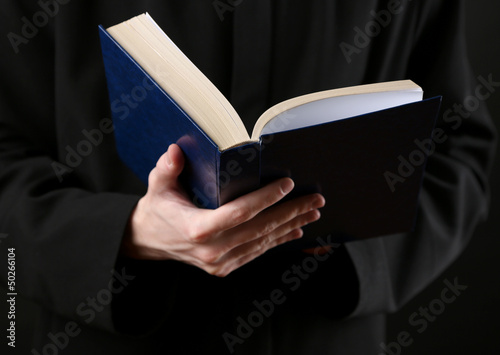 Photo: Priest reading from the holy bible, close up Priest reading from the holy bible, close up