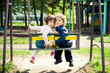 boy and girl on the swings