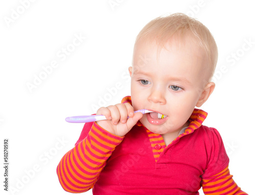 Photo: Little baby girl with toothbrush isolated on white background Little baby girl with toothbrush isolated on white background