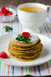 A stack of pancakes with cherry