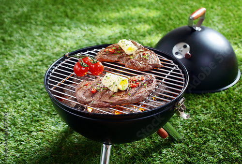 Photo: Cooking steak on a barbecue Cooking steak on a barbecue