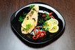 Photo: Black plate with fish meat Black plate with fish meat