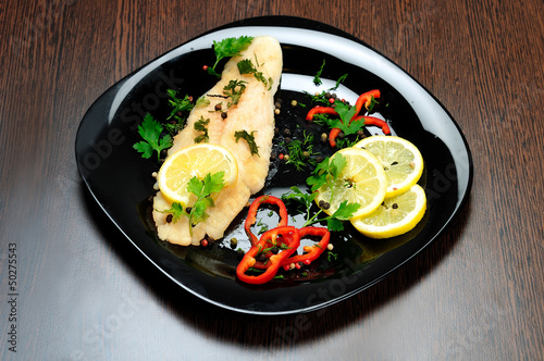 Photo: Black plate with fish meat Black plate with fish meat