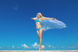 Portrait of young woman feeling free against blue sky with blowi