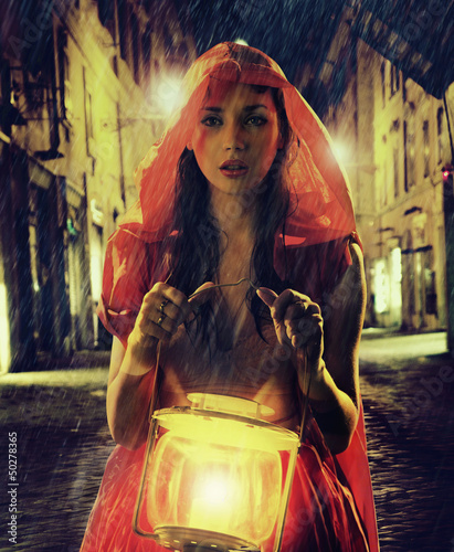 Photo: Innocent woman in red holding the lantern Innocent woman in red holding the lantern