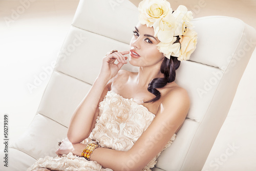 Photo: Pretty brunette woman with fabulous flower hat Pretty brunette woman with fabulous flower hat