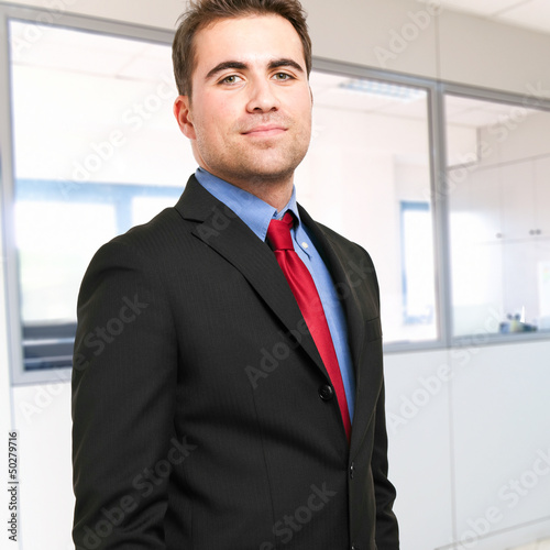 Photo: Confident businessman in his office Confident businessman in his office