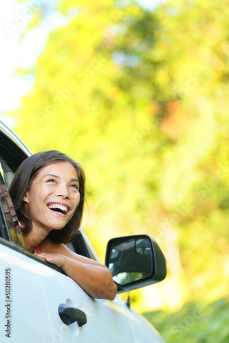 Photo: Car woman on road trip looking Car woman on road trip looking