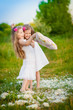 Adorable girls having fun with pillows outdoor