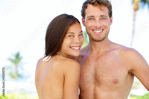 Photo: Couple beach - young multicultural people Couple beach - young multicultural people