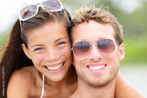 Photo: Happy young beach couple closeup portrait Happy young beach couple closeup portrait