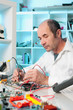 Photo: Tech tests electronic equipment Tech tests electronic equipment