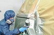 Worker painting car.