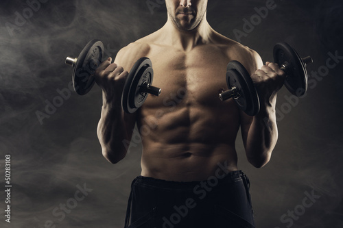 Photo: Exercising biceps with dumbbells Exercising biceps with dumbbells