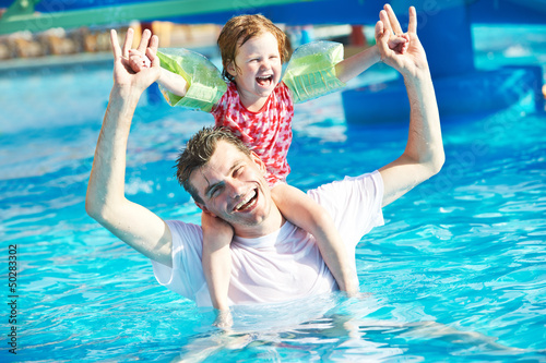 Photo: Father and child in resort swimming pool Father and child in resort swimming pool