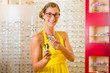 Young woman at optician with glasses