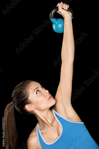 Photo: Fitness woman training crossfit with kettlebell Fitness woman training crossfit with kettlebell