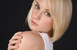 Young Vibrant Blond Woman Looks over Her Shoulder in Headshot