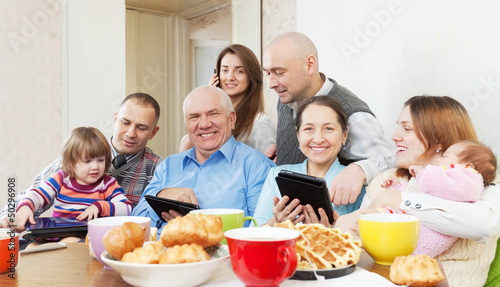 Photo: happy multigeneration family uses electronic devices happy multigeneration family uses electronic devices