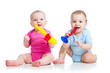 Funny children girl and boy playing with musical toy. Isolated o