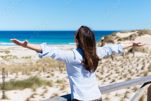 Photo: frau am strand breitet die arme aus frau am strand breitet die arme aus
