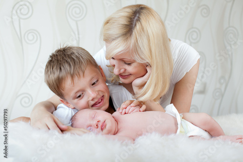 Photo: Young mother looking at her sleeping baby Young mother looking at her sleeping baby