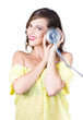 Woman listening with tin can phone to ear