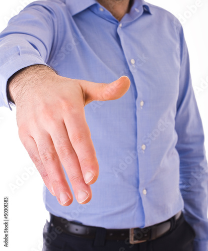 Photo: Young business man giving hand. Young business man giving hand.
