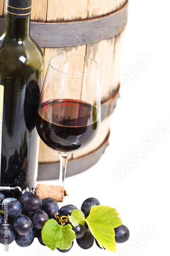 Photo: Glass of a red wine, bottle, barrel and grapes Glass of a red wine, bottle, barrel and grapes
