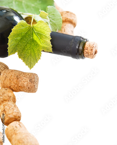 Photo: Bottle corks and bottle on the white background Bottle corks and bottle on the white background