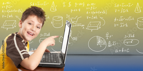 Photo: Young boy with laptop computer. Young boy with laptop computer.