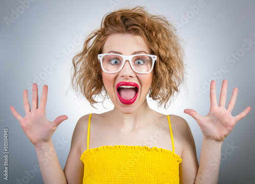 Photo: Happy surprised woman screaming with open hands Happy surprised woman screaming with open hands
