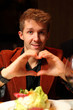 Happy young man with his hands depicting heart