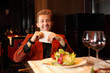 Happy young man in a red suit holding a napkin