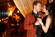 to a good girl flirting young man with a glass of wine