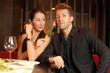 woman holds in her hand flower and flirting with young man