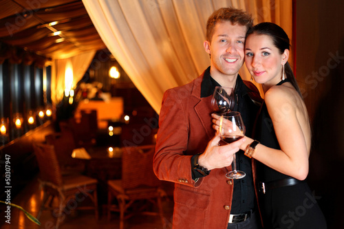 Photo: the restaurant hugging young man and beautiful woman the restaurant hugging young man and beautiful woman